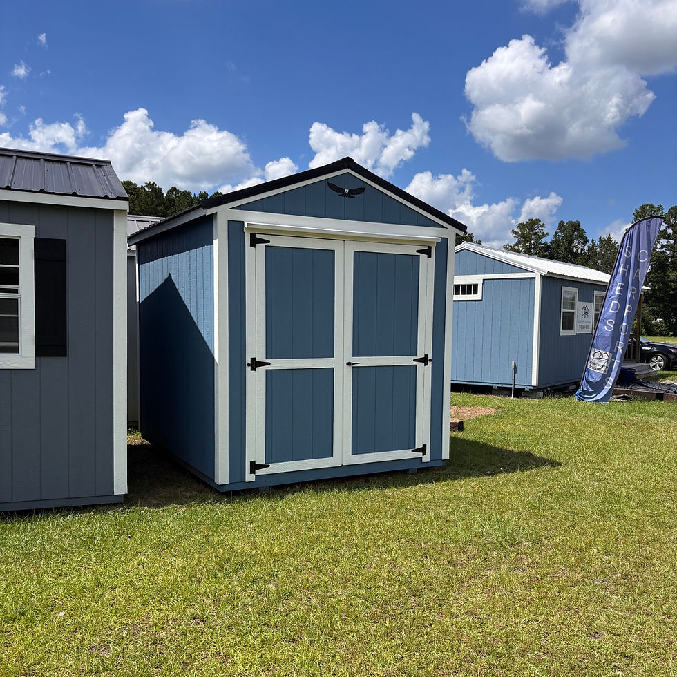 Thumbnail: 8x10 Utility storage shed with double doors, blue siding, white trim and black metal roof displayed on the Moncks Corner lot.