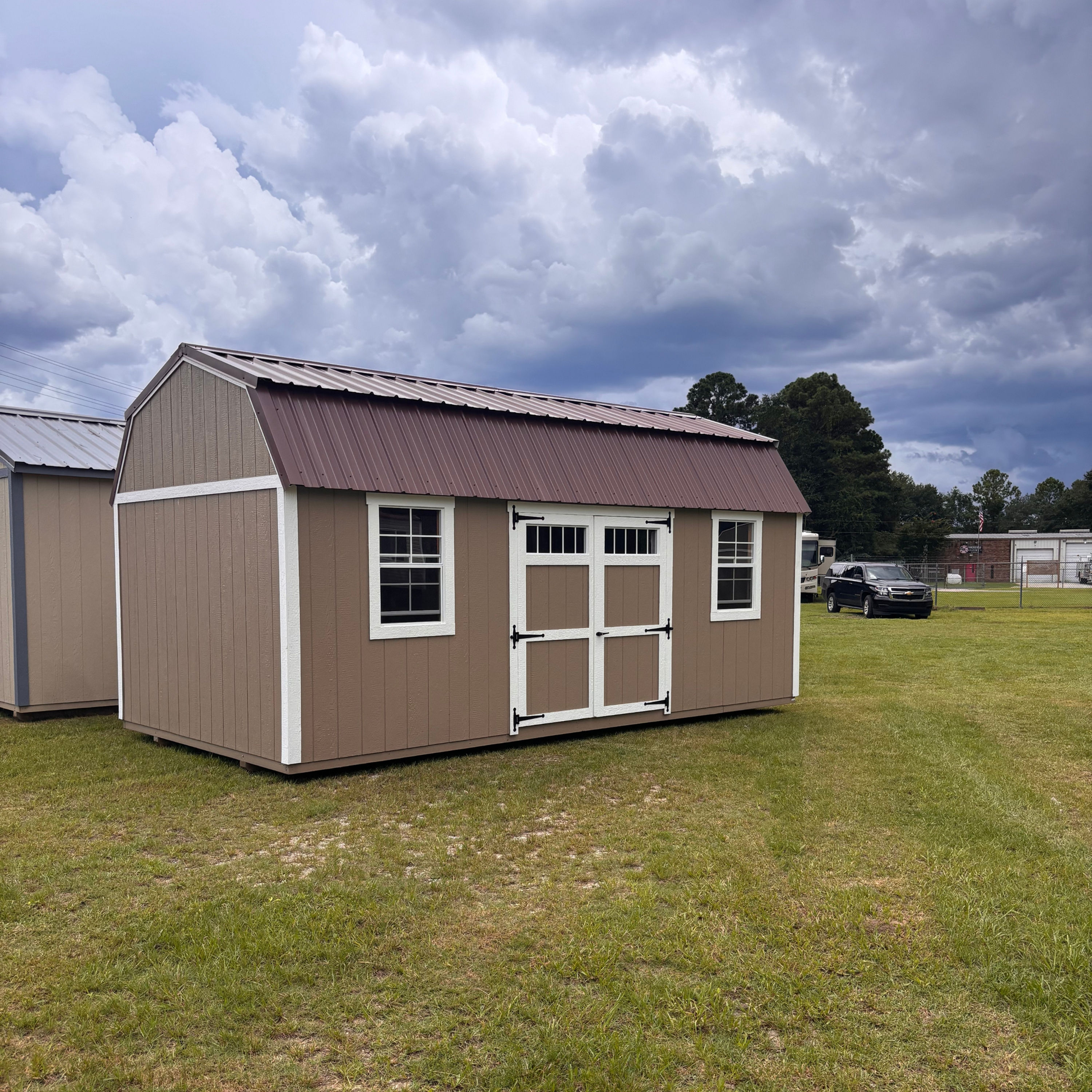 10x20 Side lofted barn shed double doors, two windows, tan paint, white trim and metal roof in Moncks Corner.