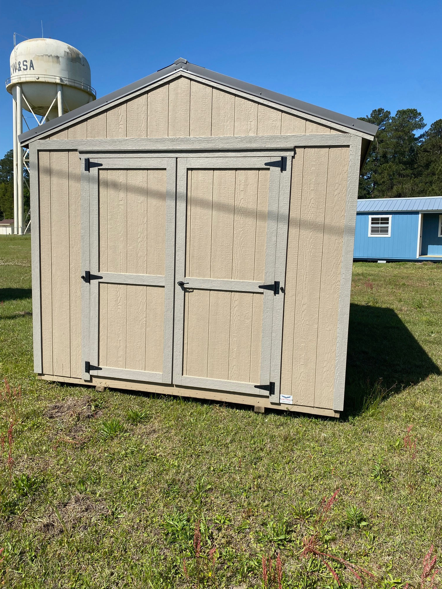 10x16 Utility storage shed with double wood doors, buckskin paint, clay trim and metal roof in Moncks Corner.