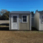 Front view of 8x10 storage shed showing 9-lite house door and window, perfect for Dorchester County backyards.