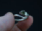 Moldavite sterling silver snake ring in fingers for size