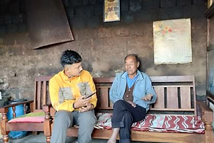 Theja discussing with elders.png
