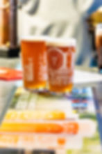 Two beer glasses with white architectural designs