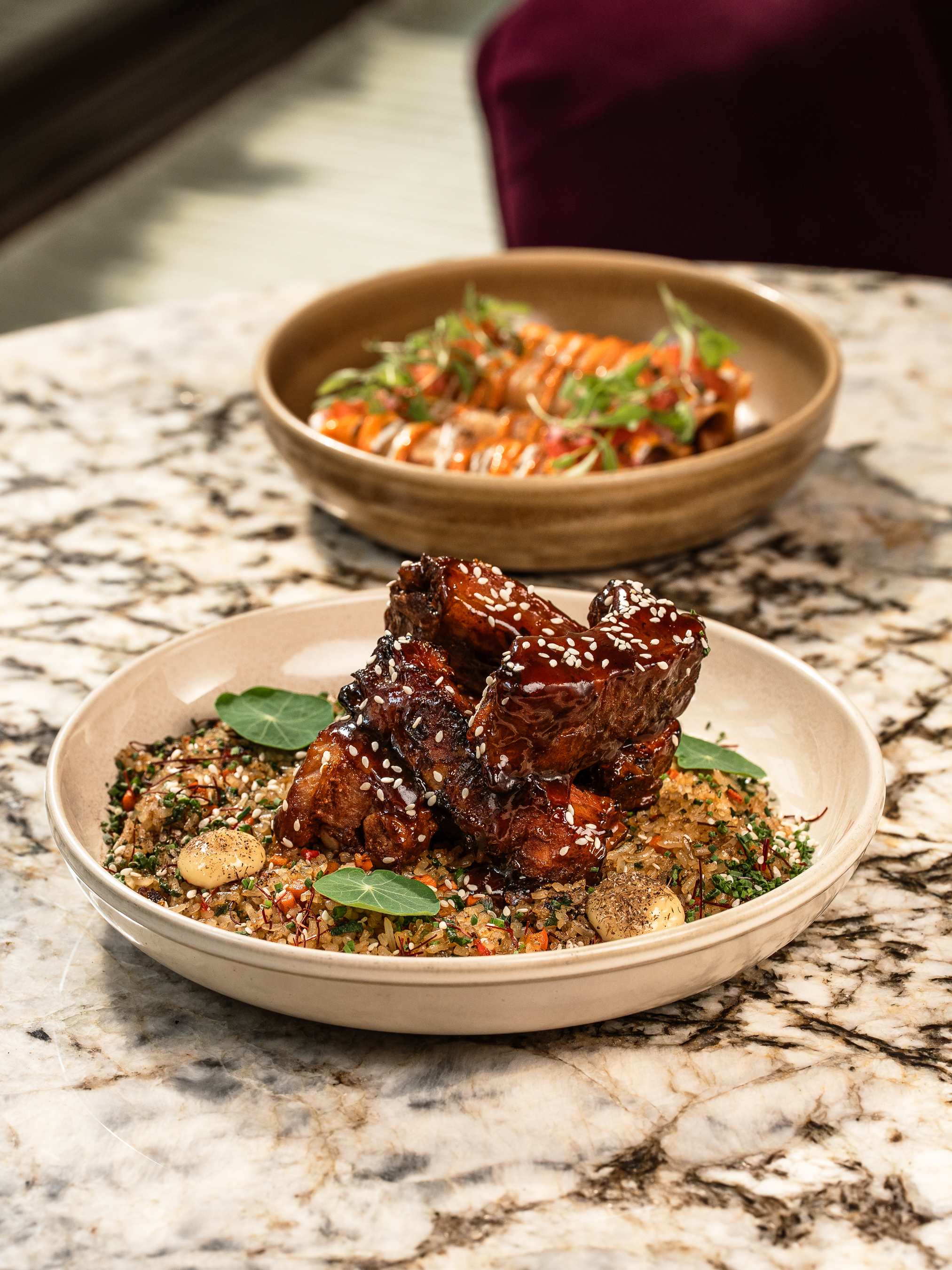 Glazed meat and grain bowls at La Estrella Barra Local