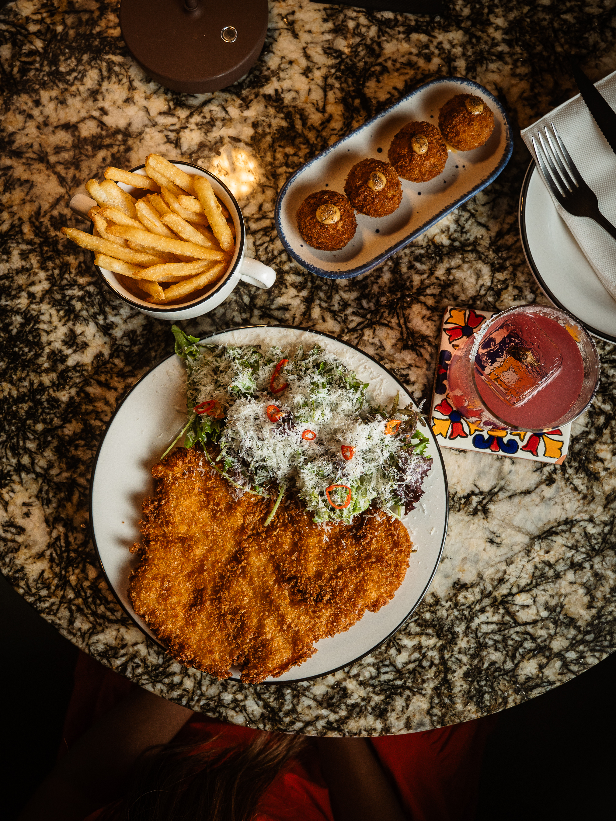 Shared food spread with fries at La Estrella Barra Local