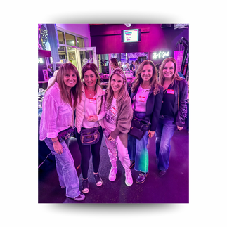 Group of midlife women posing together at a wellness event, celebrating friendship and community connection.