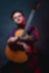 George Wood holding a guitar