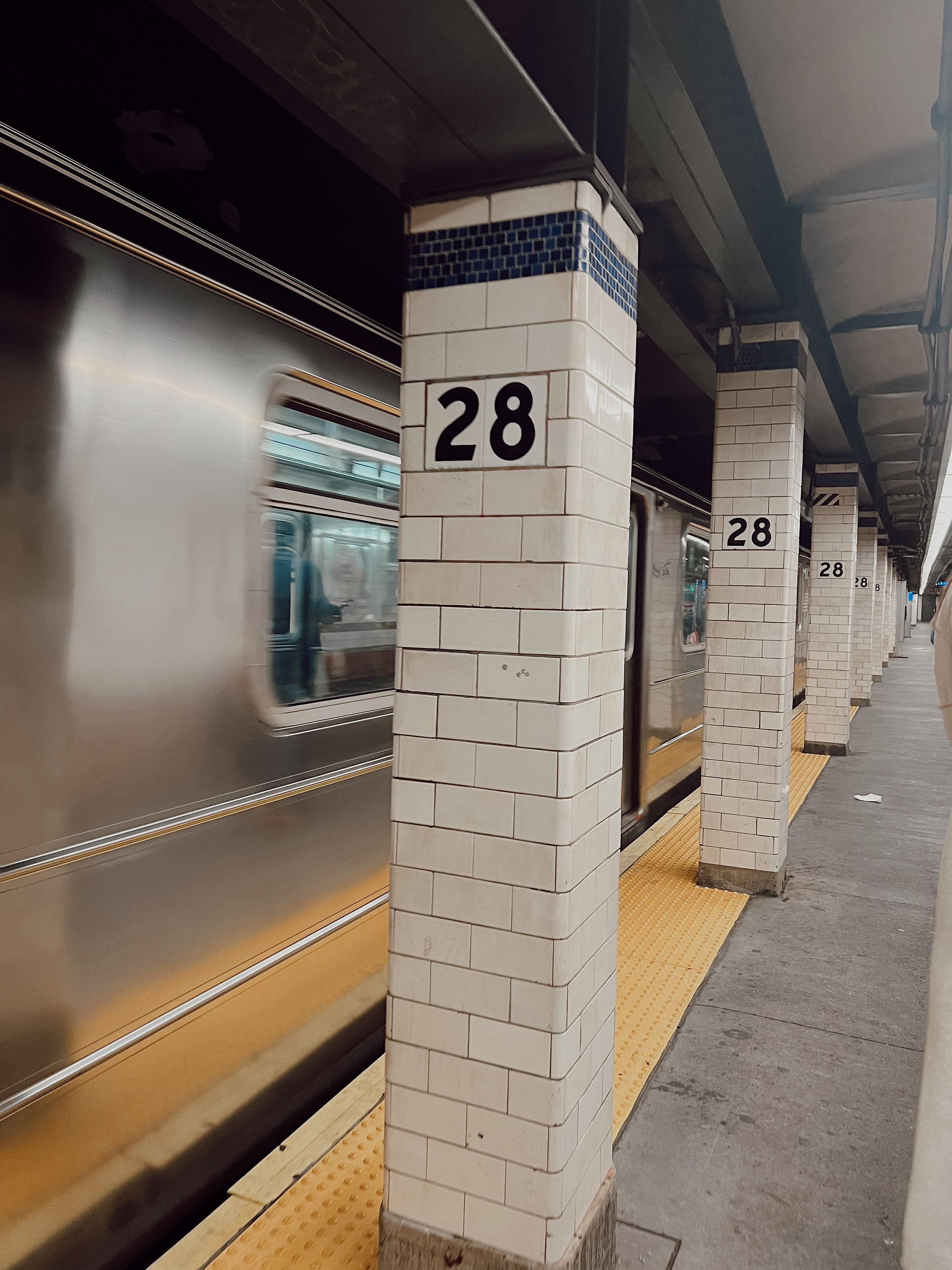 Photo of a subway pillar with the number 28 on it