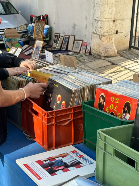 flipping through records at an outdoor flea market