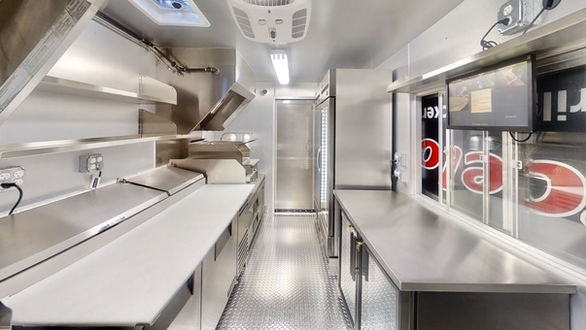 Cooking surfaces in the Barcelos USA food truck, featuring stainless flat tops and char broilers, showcasing the quality of food truck building in Nashville.