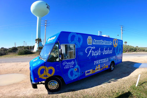 Driver side view of Auntie Anne's custom food truck built by Premier Food Trucks in Jacksonville, Florida. Perfectly showcasing our expertise in food truck building.