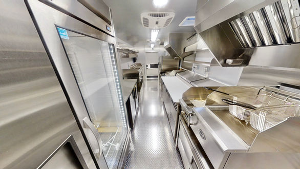 Interior view of True commercial fridges inside Barcelos USA custom food truck, highlighting the top-tier equipment in this expertly built mobile kitchen.
