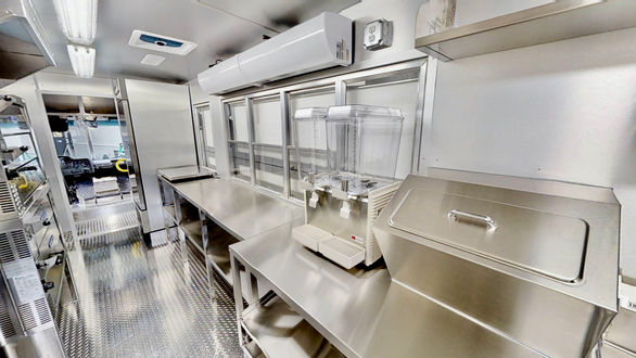 Side view of Auntie Anne's custom food truck in Tampa, Florida, showcasing the refrigerator side, a key component for efficient food truck operation.