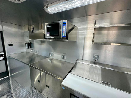 Premier Food Trucks designed custom cabinets and installed a microwave in this build, perfect for those looking to build a food truck with efficiency in mind.