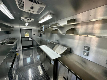 The spacious interior of this food truck, built by Premier Food Trucks, showcases quality workmanship, ideal for clients seeking a food truck builder in USA