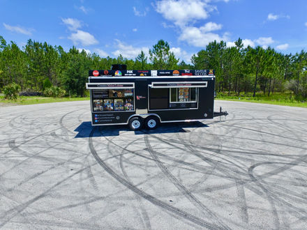 A zoomed-out view of the Cousins Maine Lobster trailer, showcasing its size and design. Ideal for those seeking to buy a custom food truck.