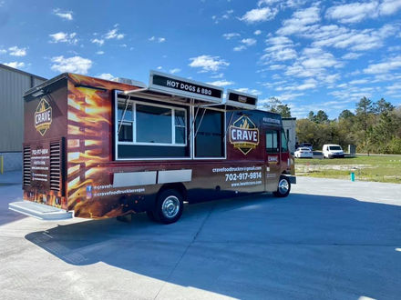 The serving side of the Crave BBQ food truck with open awnings, a prime example of a customize food truck built for functionality and style.