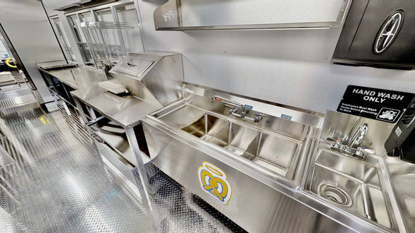 Interior shot of the 3-bay sink and hand wash sink in Auntie Anne's food truck, ensuring top hygiene standards in Tampa, Florida.