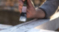 male-hand-paints-with-white-paint-wood-painting-concept-close-up-place-text (1).jpg