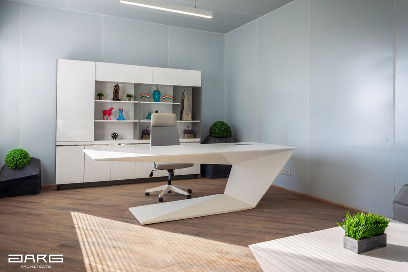 a modern office with a white desk and chair