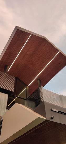 a building with a wooden ceiling and a balcony