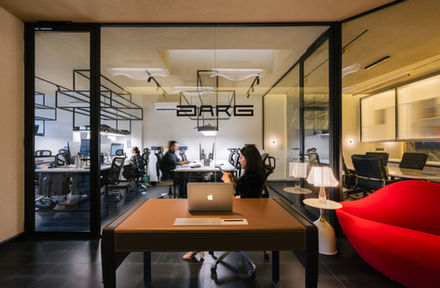 Modern office with people working at desks.