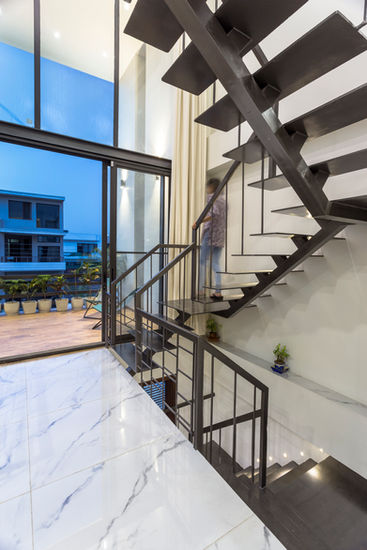 a woman is walking down a set of stairs in a house