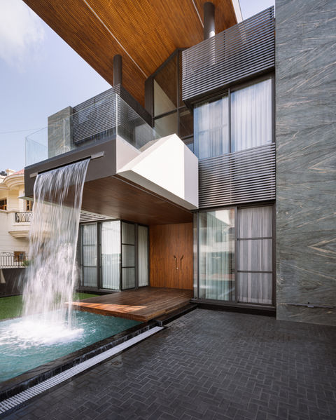 a house with a waterfall in front of it