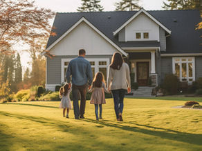 A family walking together towards their house in the fall