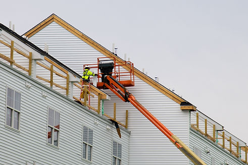 Worker fixing and installing new home siding