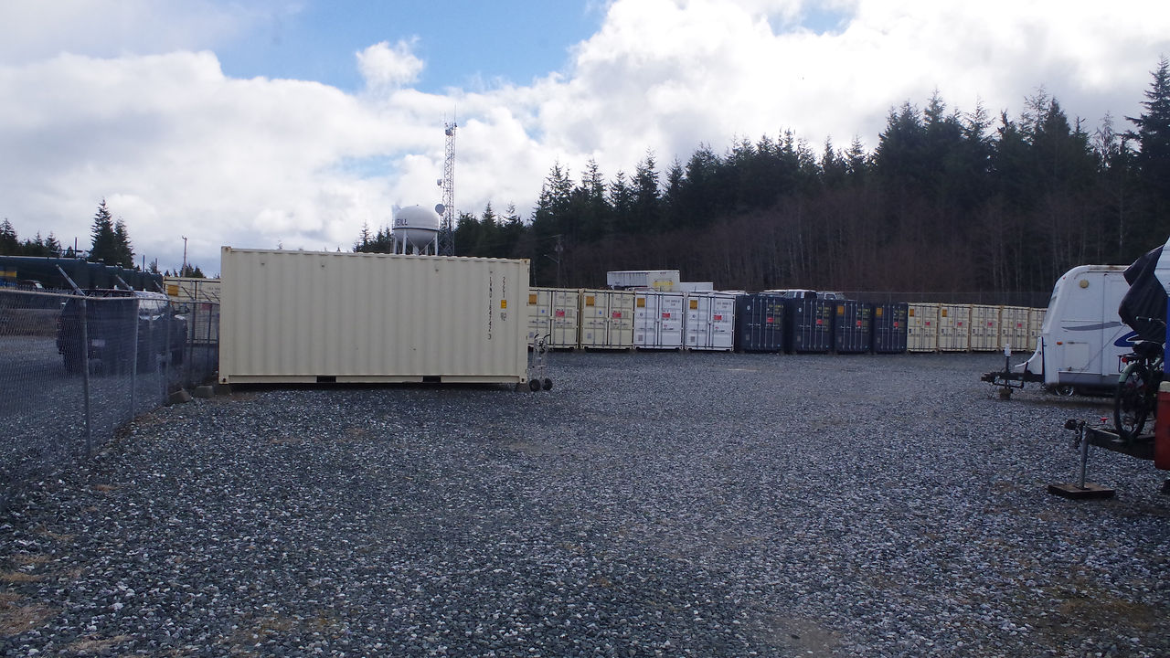 A far off view of a storage facility with several shipping containers