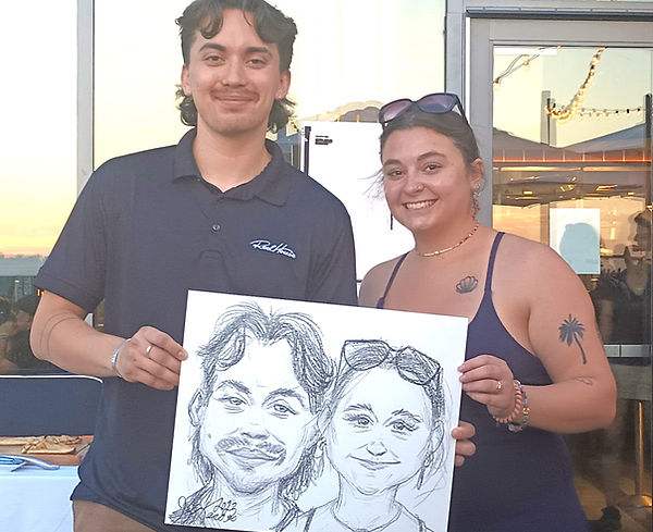 Guests holding a live caricature drawing at an event served by Boston Caricature Artists in Danvers, MA