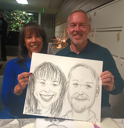 Guests holding a live caricature drawing at an event served by Boston Caricature Artists in Billerica, MA