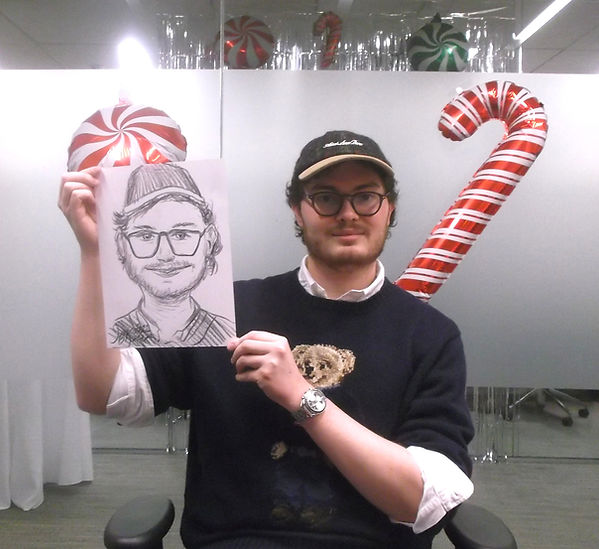 Live caricature entertainment at a festive holiday celebration.