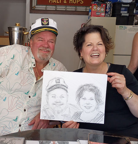 Couple holding their finished caricature drawing at an event served by Boston Caricature Artists in Wakefield, MA