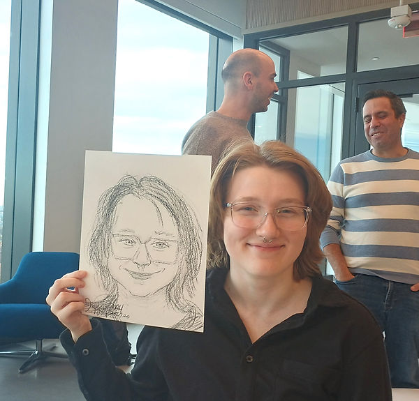 Company guests enjoying personalized caricature artwork.