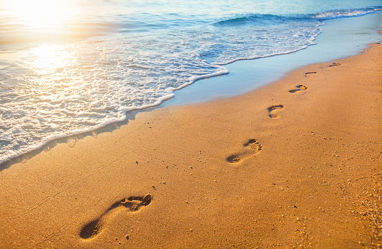 beach, wave and footprints at sunset time.jpg