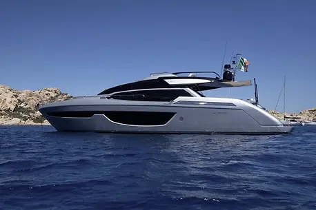 Riva Perseo 76 luxury yacht anchored in a crystal-clear bay in Northern Sardinia.