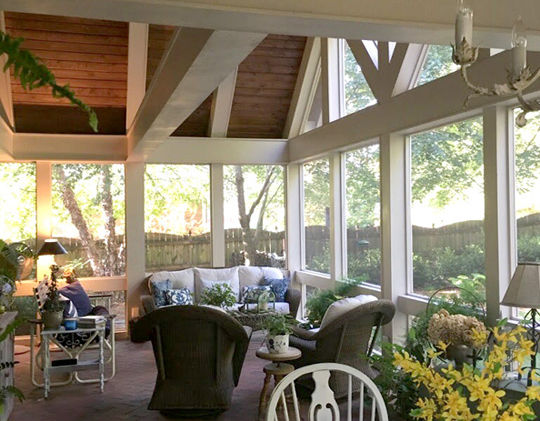 Interior of porch addition with vaulted ceiling and open trusses