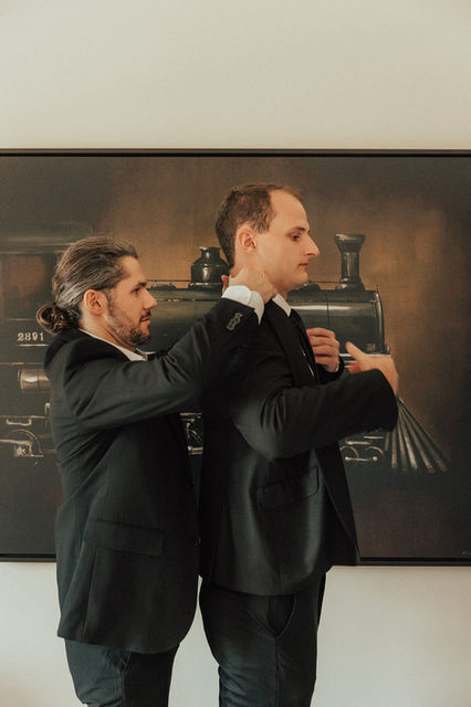 Groom gets dressed with help of best man at the emerson estate