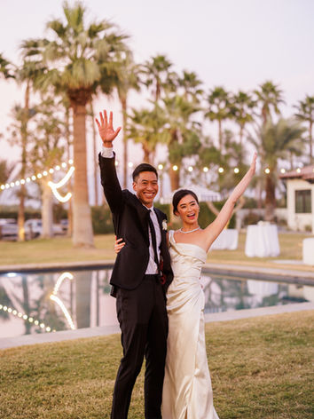 Bride and groom cheers pool side at the Emerson Estate wedding venue palm springs