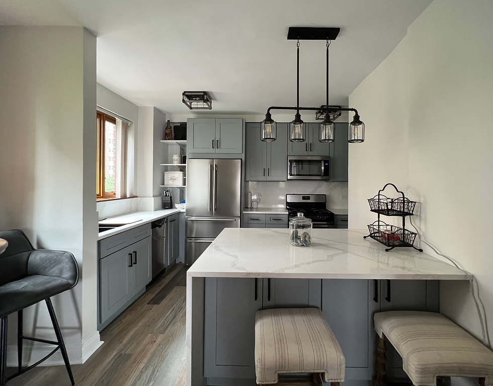 Renovated kitchen with gray shaker cabinets, quartz countertops, matte black hardware and upgraded l