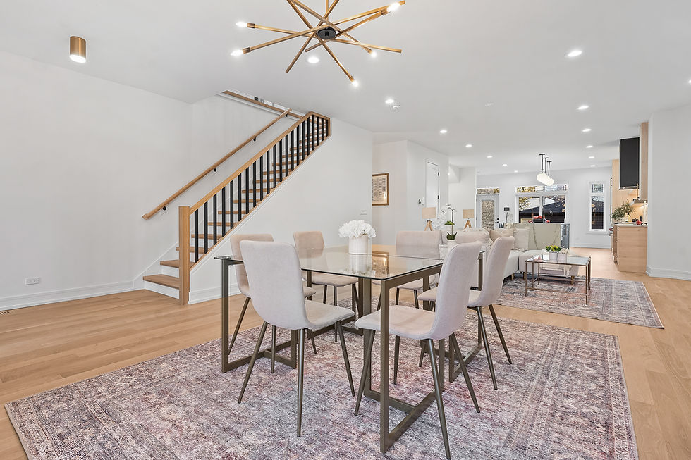 Spacious dining area and family room with modern lighting and oak flooring.