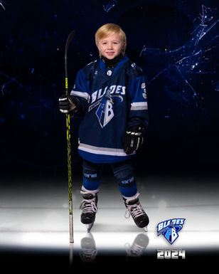 Young Blades U7 hockey player in full hockey equipment posing for an individual sports portrait.