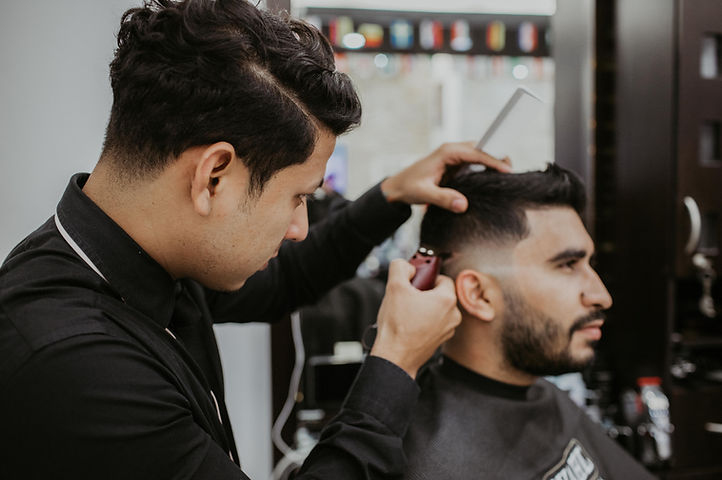 man-trimming-another-man-s-hair-1453003.