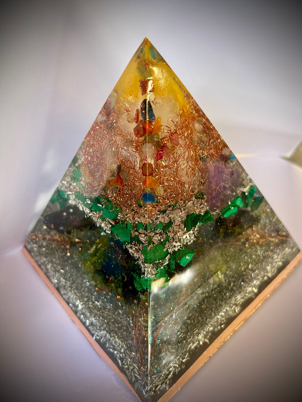 Close-up view of an orgonite pyramid with vibrant colors