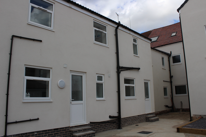 Rear view of the refurbished Anlaby Road property with new render, windows and courtyard access.