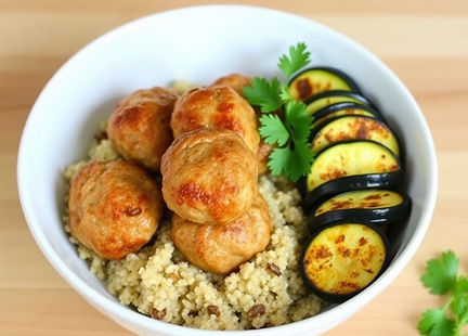 Turkey meatballs over quinoa with roasted zucchini on the side.