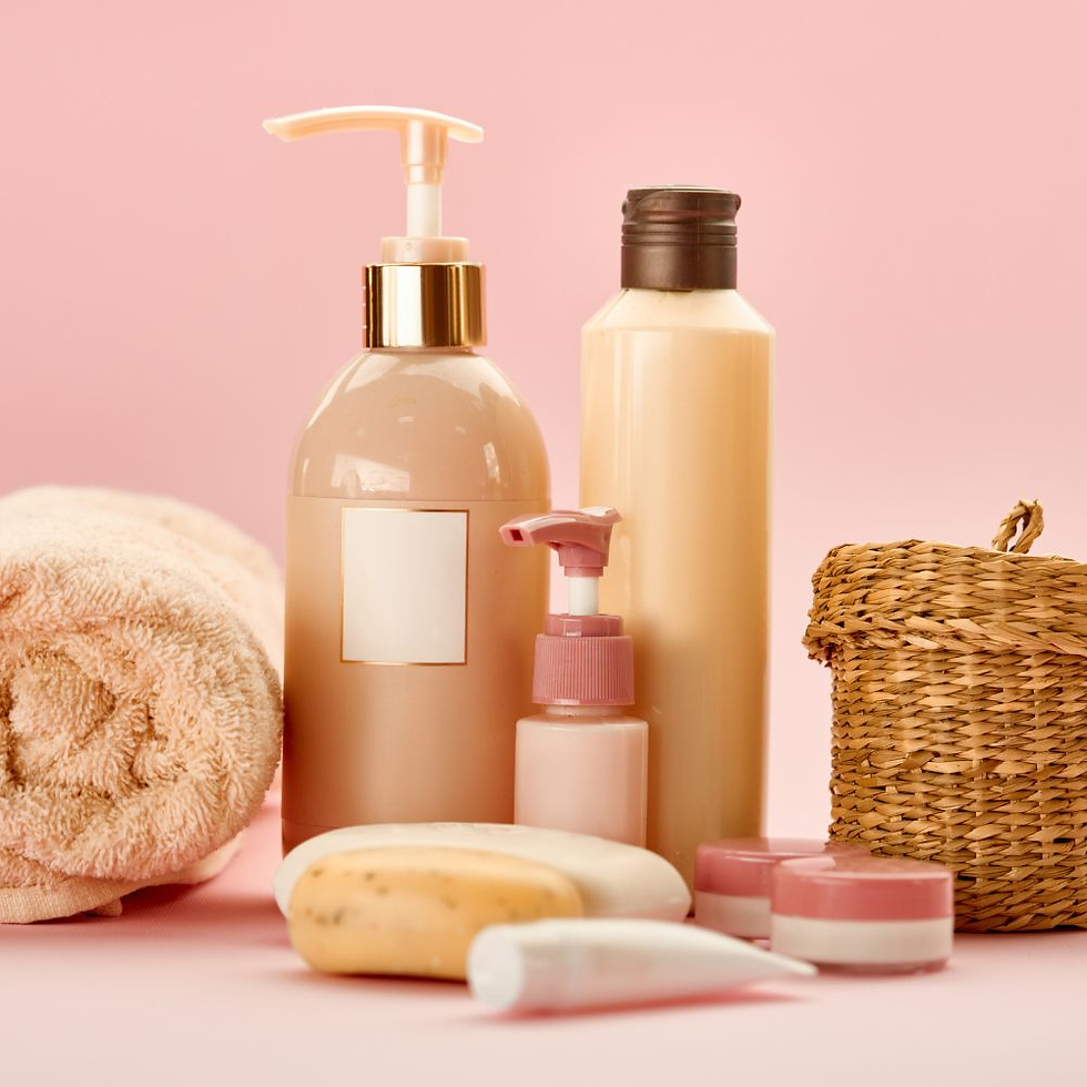 Pink-themed toiletries on a soft pink background, including lotion bottles, soap, a towel, and a wicker basket, creating a calm mood.