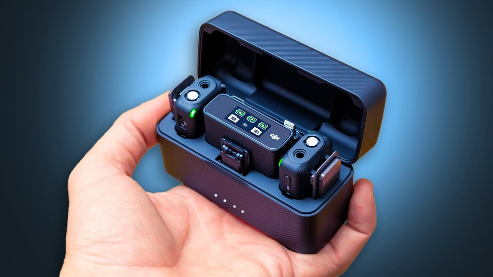Hand holding a black charging case with wireless microphones and a display showing green icons. Blue gradient background.